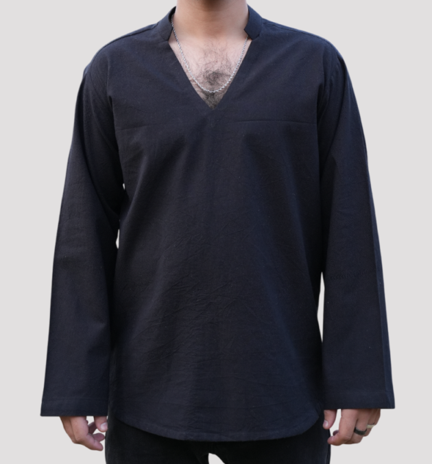 A man wearing a black split-neck shirt with long sleeves and a minimalist design, ideal for casual and semi-formal wear.